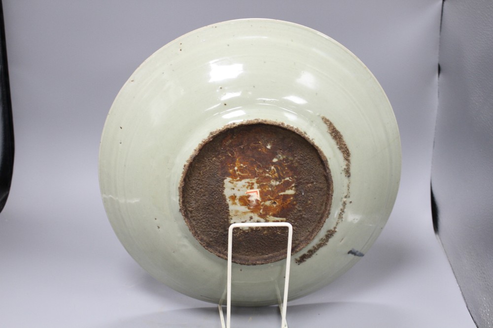 A Chinese Ming celadon dish, Zhangzhou kilns, c.1580-1620, incised with fish and water plants, diameter 38.5cm, height 8cm